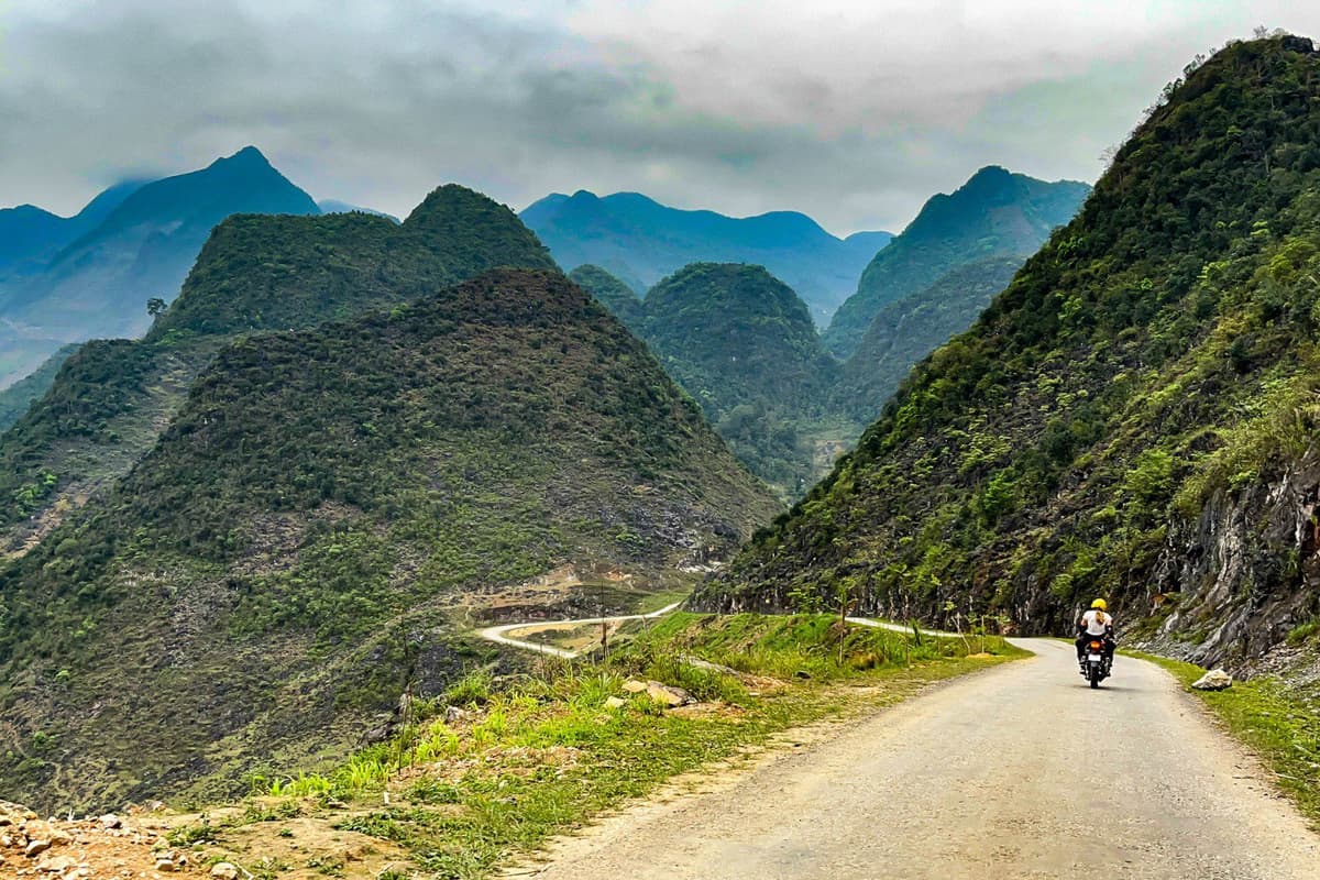 What to Do in Vietnam: Top 10 Must-Dos 9 Motorbikes on the Ha Giang Loop wind past terraced hills and misty mountain passes.