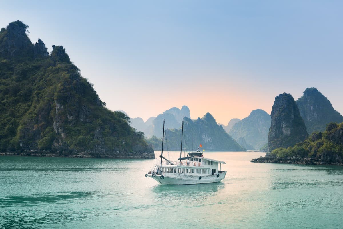 What to Do in Vietnam: Top 10 Must-Dos 1 The emerald waters of Ha Long Bay shimmer as cruises glide between limestone peaks.