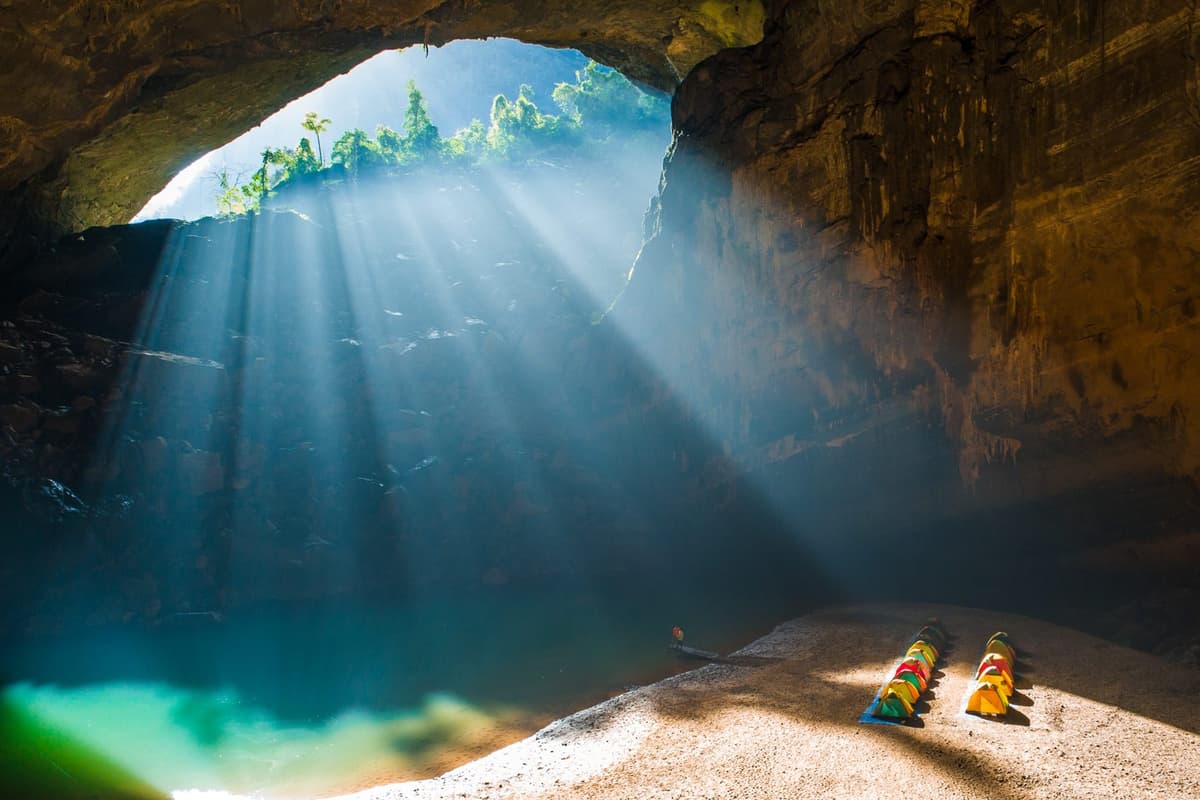 Sunbeams stream deep into Hang En cave
